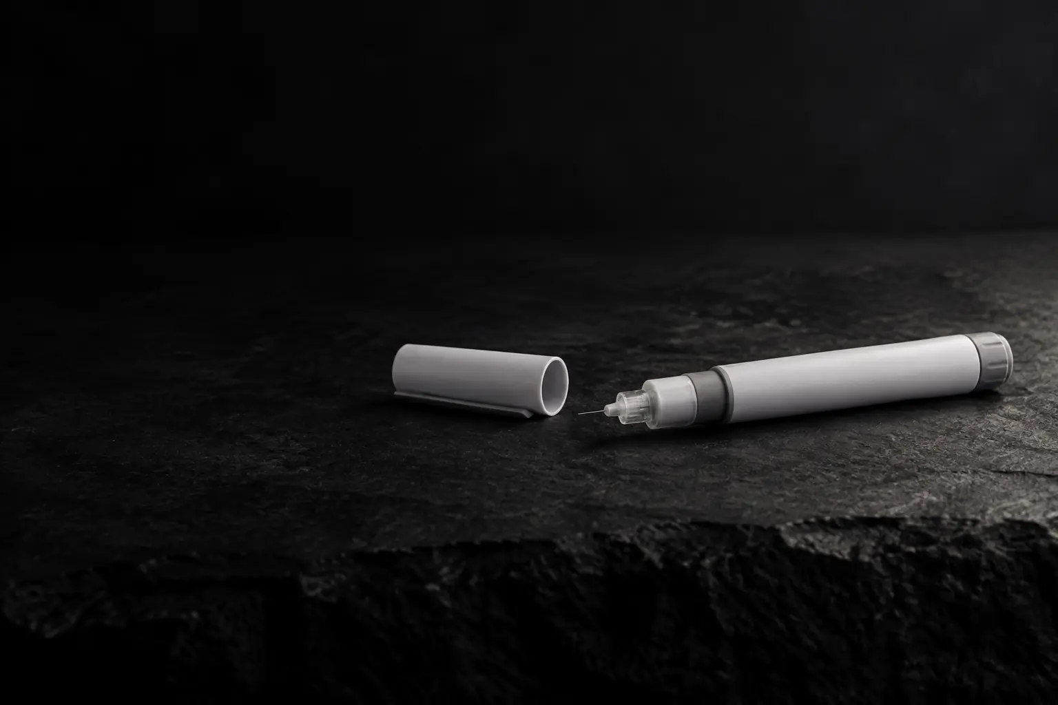An unbranded white and grey injection pen with its cap off
