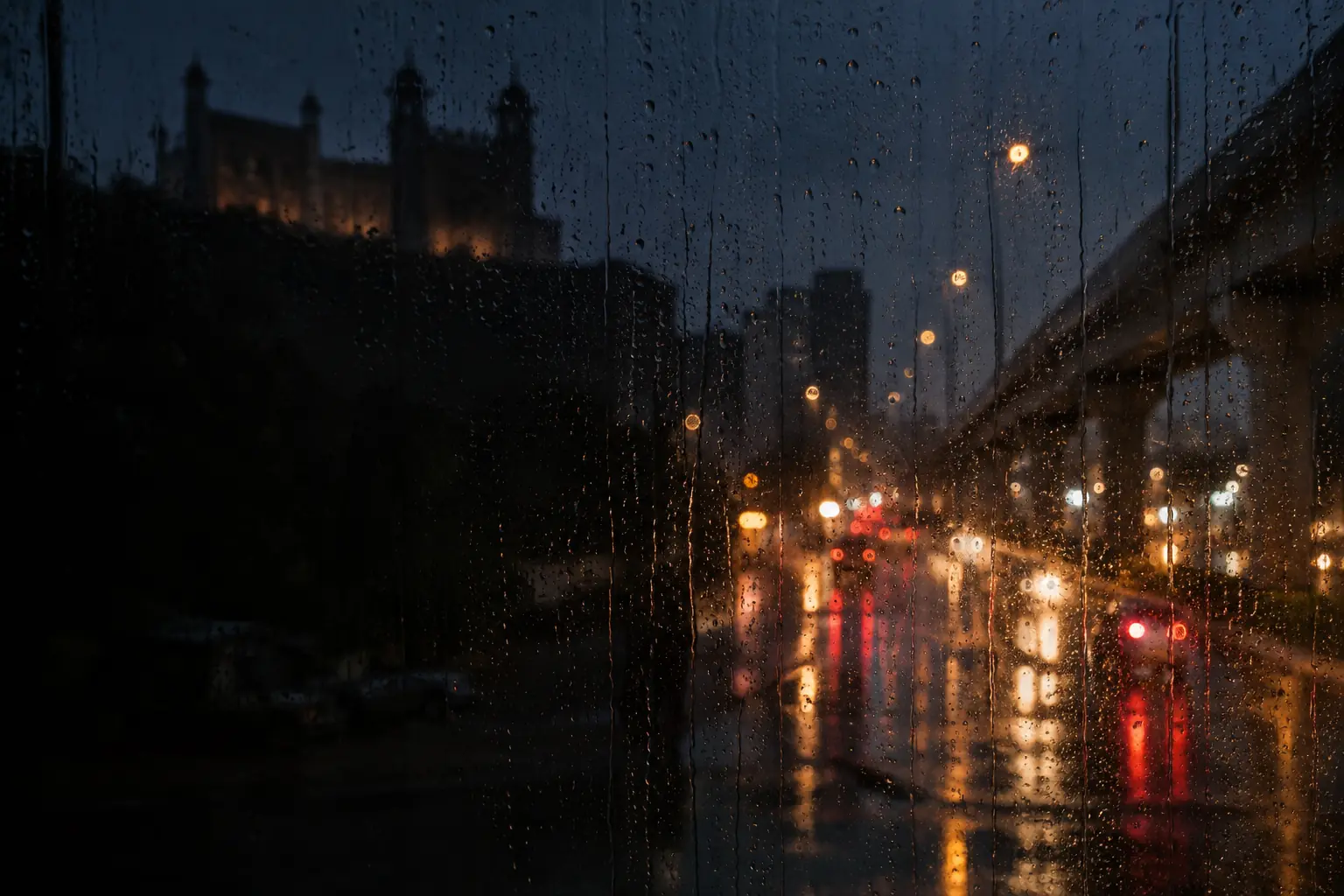 Monsoon rain running down a window